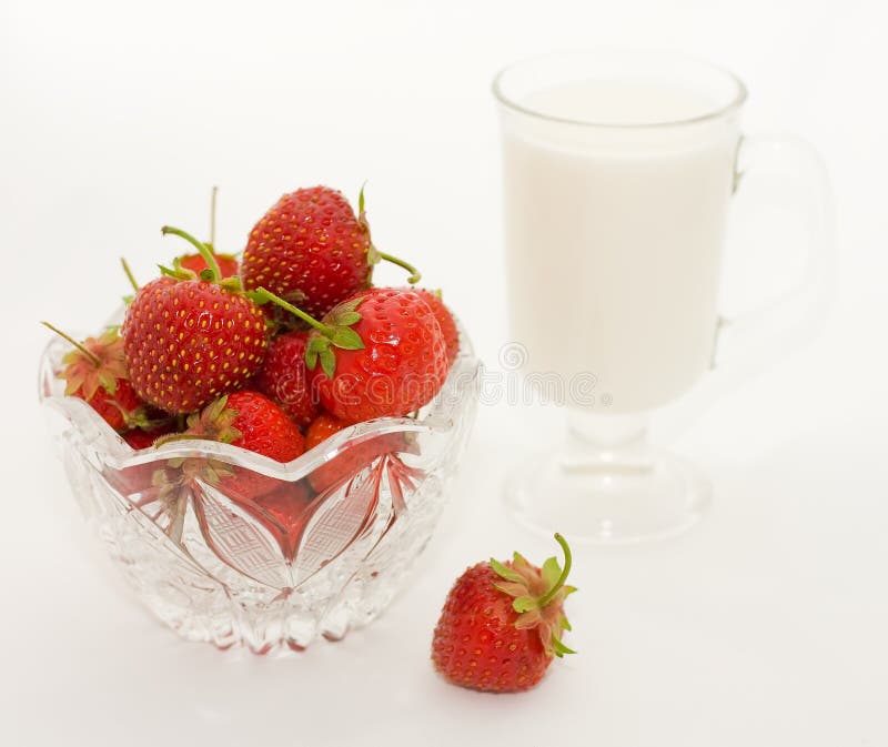 Glass cup with milk and berries