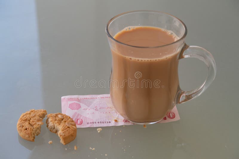 Glass Cup of Milk Tea, Turkish Banknote, Cookie Pieces Stock Photo