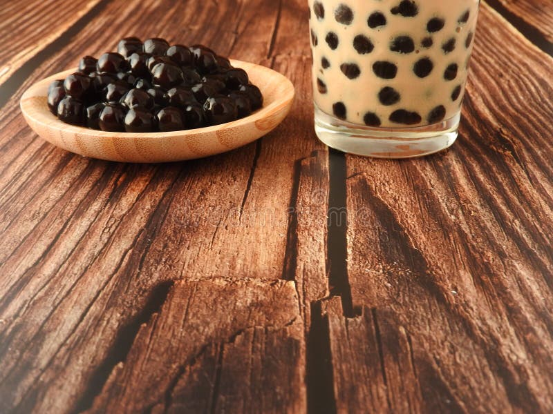 A Glass Cup of Pearl Milk Tea Also Called Bubble Tea and a Plate of Tapioca  Ball on Wooden Background. Stock Photo - Image of glass, beverage: 191605372