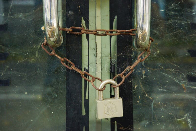 The Glass Door is Locked with an Iron Padlock. Editorial Photo Image