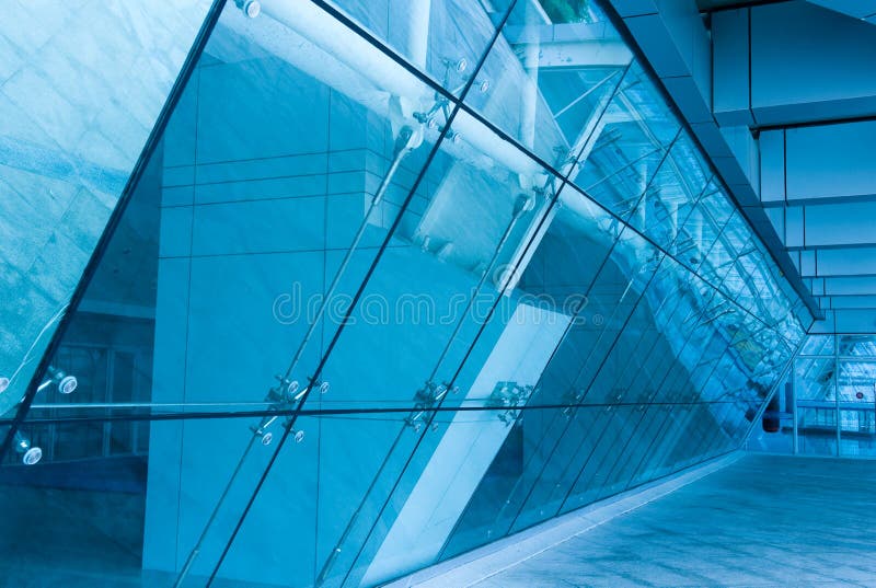 All-glass entrance to modern building. Digitally modified in blue tone.