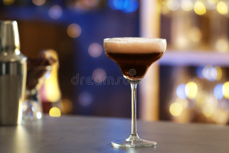 Glass of Espresso Martini on Counter in Bar. Alcohol Cocktail Stock