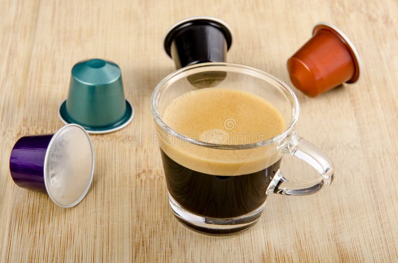 Nespresso cup of fresh made espresso lungo with empty capsule Stock Photo -  Alamy