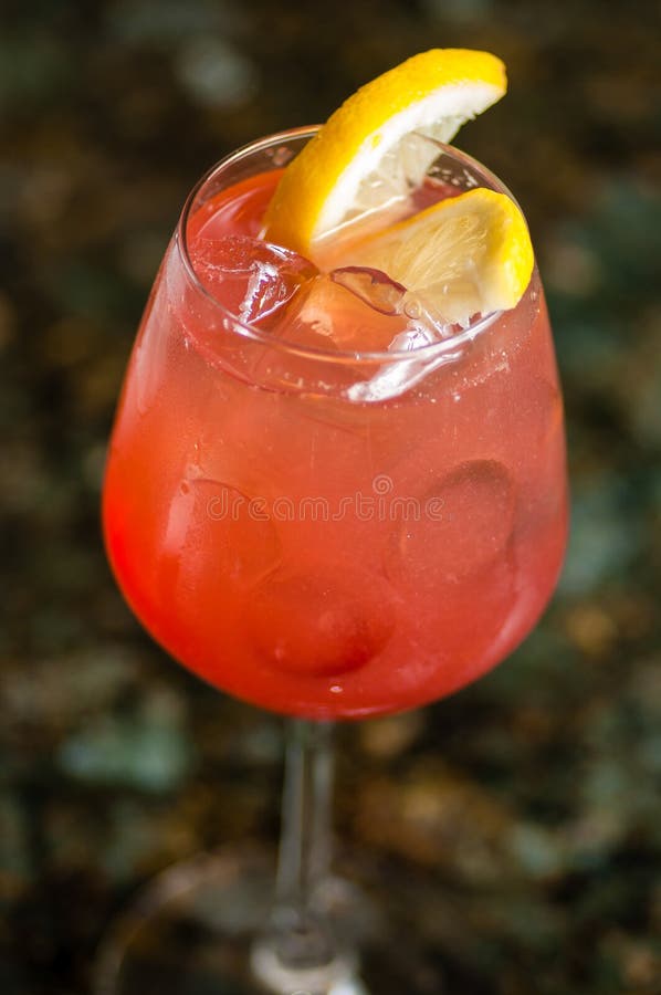 Glass filled with red cocktail