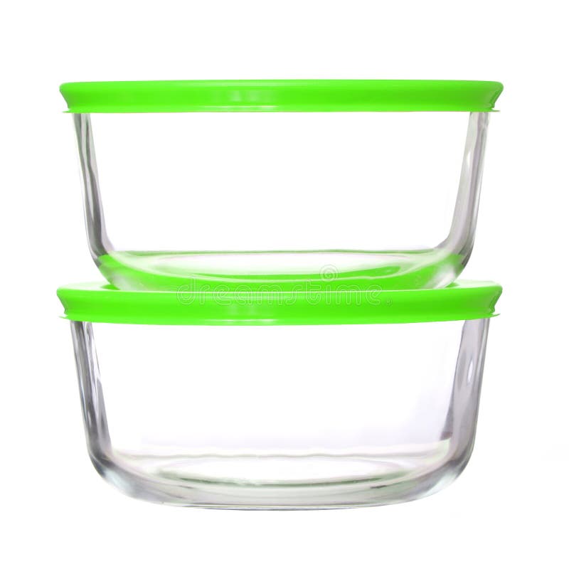 Glass food containers with green plastic lids on white royalty free stock photos