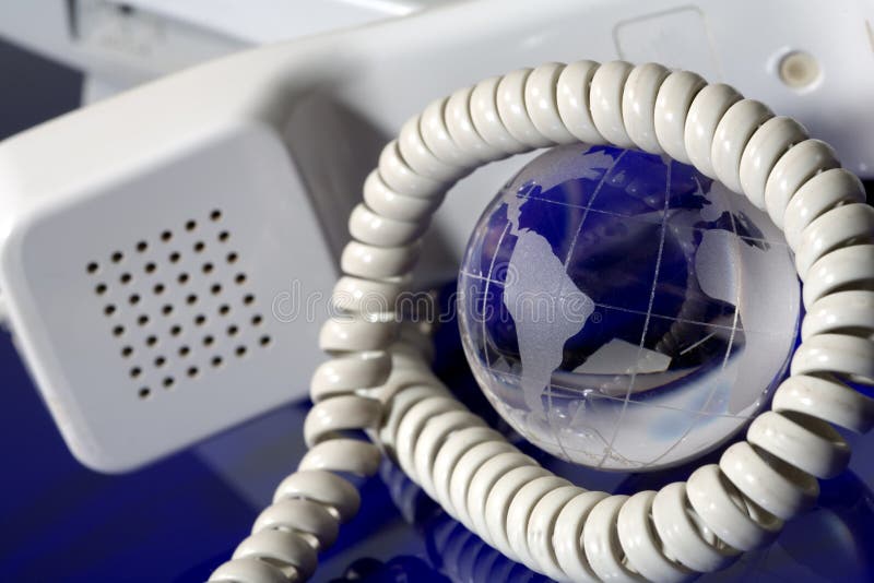 Glass globe with phone stock photo. Image of contact 13288938