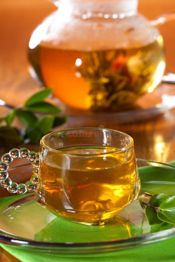 Glass of greean tea and teapot