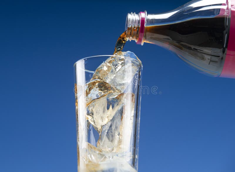 Glass with Ice and Bottle with Carbonated Drink. Stock Photo Image of