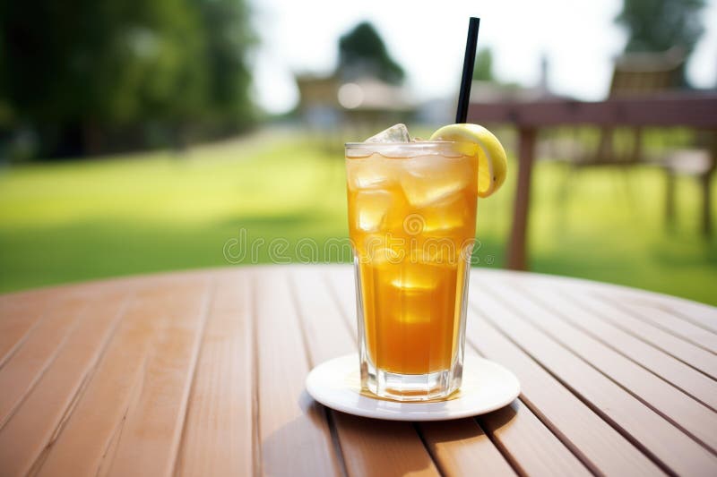 Glass of Iced Tea and Lemonade Mix on Golf Course Table Stock