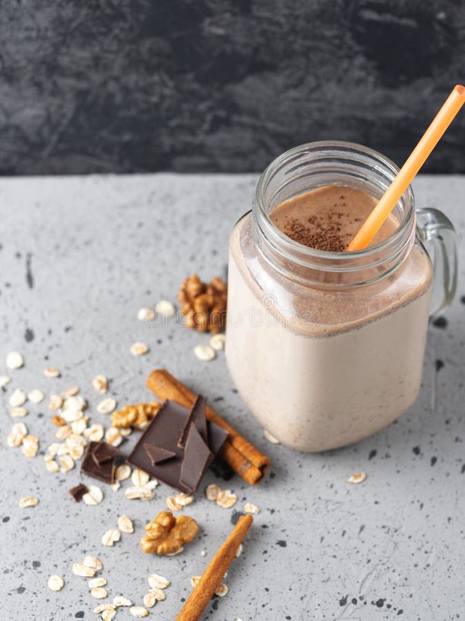 Glass Jar of Chocolate Coffee Milk Smoothie Cocktail on Grey Table with