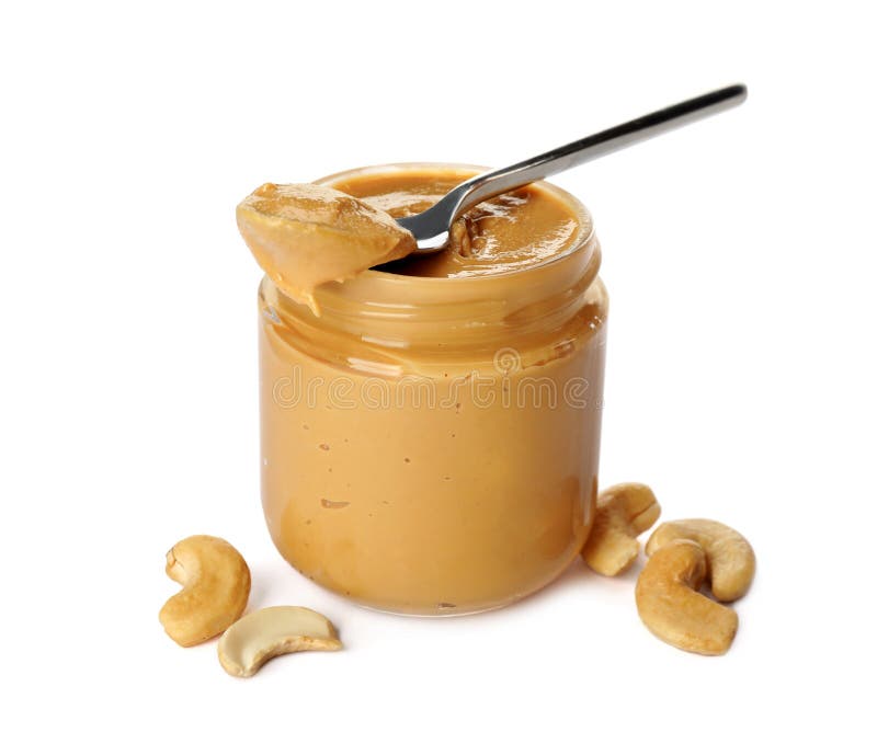 Glass jar of creamy cashew butter and nuts on white background
