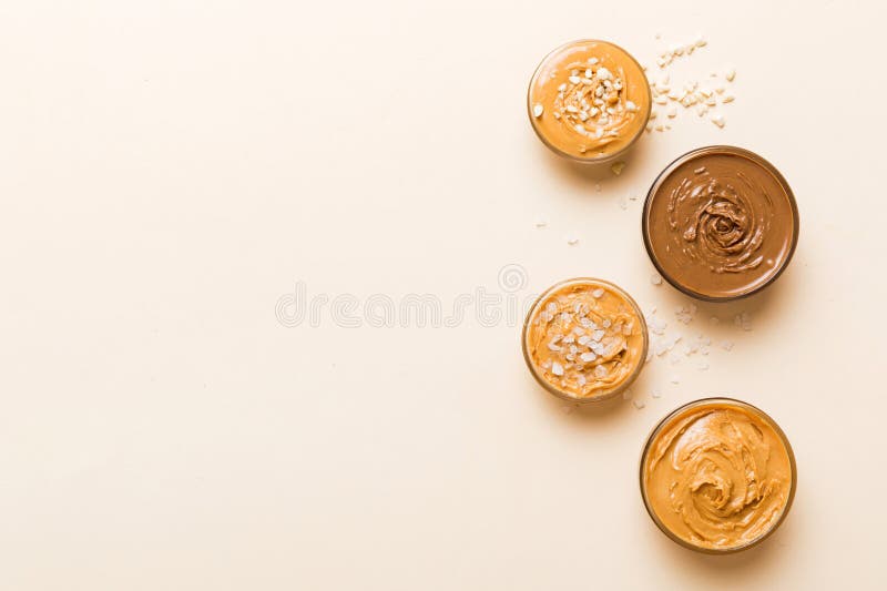 Glass Jar with Peanut Butter on Table Background, Top View Space for