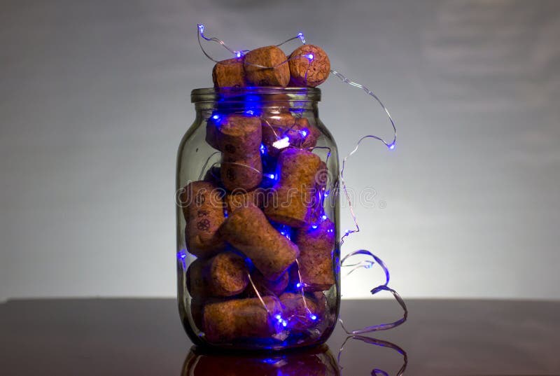 Glass jar with wooden stoppers and Christmas lights. New year and Christmas. stock photos Glass jar with wooden stoppers and Christmas lights. New year and Christmas. stock photos