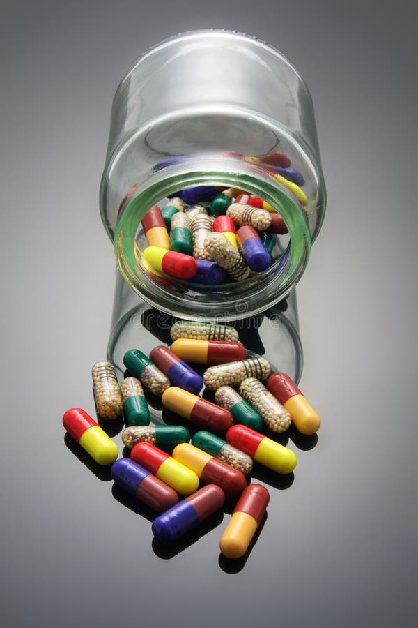 Pills and Glass Jar with Reflection. Pills and Glass Jar with Reflection