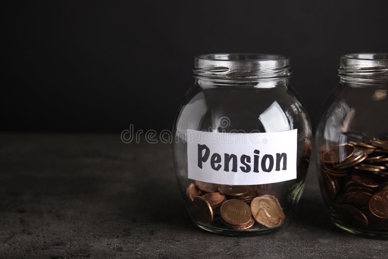 Glass jars with coins and label PENSION on dark table royalty free stock images Glass jars with coins and label PENSION on dark table royalty free stock images
