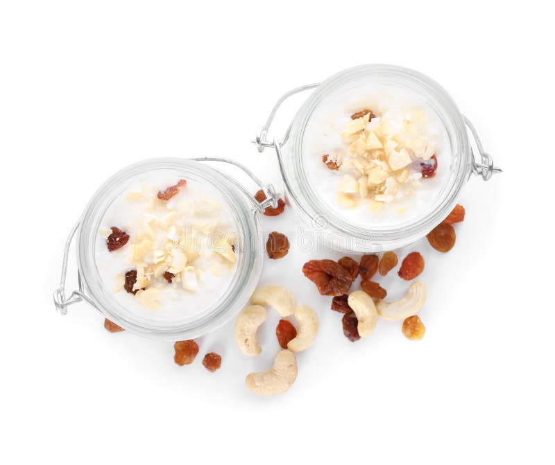 Glass Jars with Delicious Rice Pudding, Raisins and Nuts on White