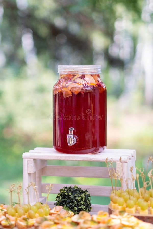 Glass jars of lemonade on wedding candy bar. Catering. Drinks on wedding party.