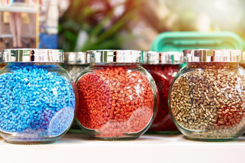 Glass jars with plastic colored granules royalty free stock photography