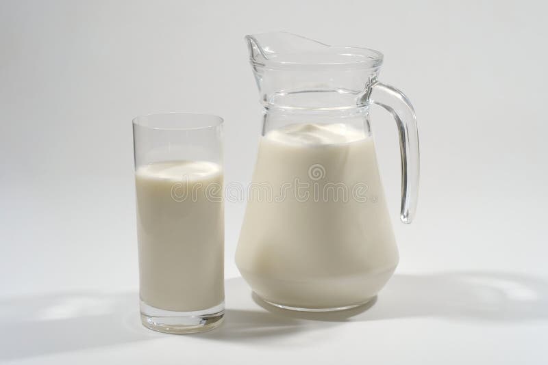 Glass and jug of fresh milk on a gray background. Dairy product royalty free stock photo Glass and jug of fresh milk on a gray background. Dairy product royalty free stock photo