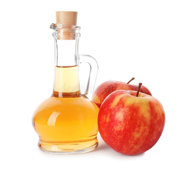Glass jug of vinegar and fresh apples stock images