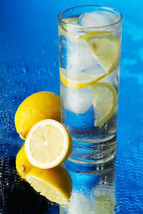 Glass of Lemon Ice Water on Blue Background Stock Image Image of