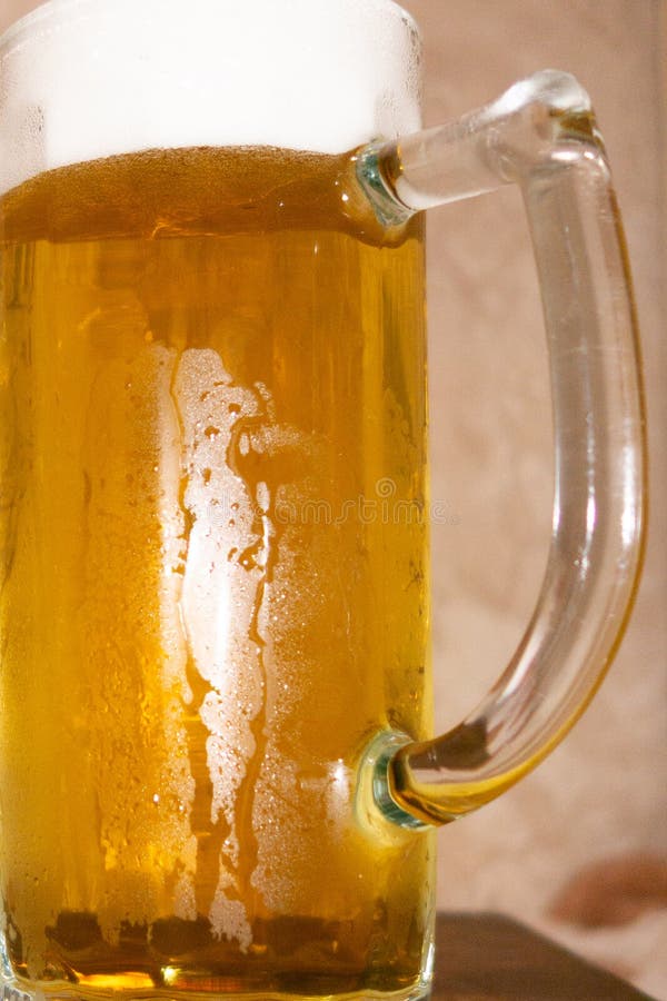 Glass of light cold frothy beer, nuts on an old wooden table. stock photos Glass of light cold frothy beer, nuts on an old wooden table. stock photos