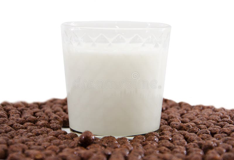 Glass of Milk and Chocolate Balls on White. Cereal. Stock Photo Image