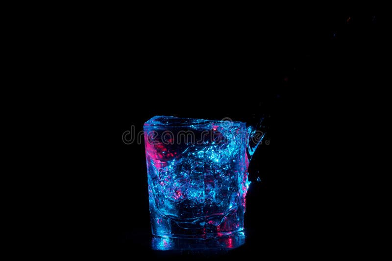 Glass Overflowing with Blue Lit Water on a Black Background Stock Image -  Image of color, movement: 126966615