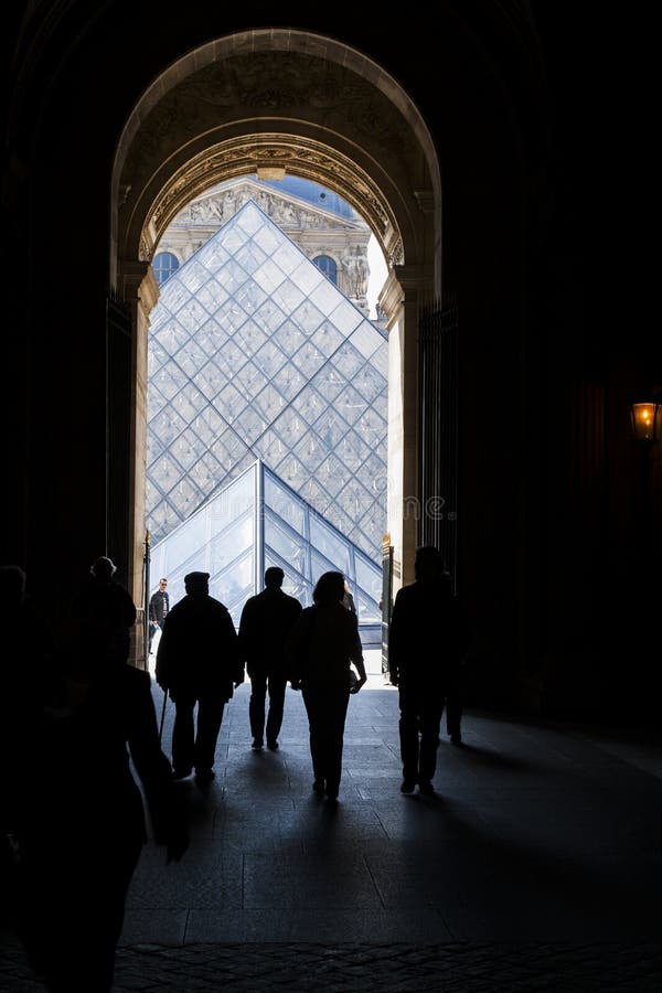 PARIS - APRIL 16, 2008. Silhouettes Louvre visitors against Glass Pyramid on April 16, 2008. The Louvre is one of the world's largest museums and one of most central landmarks of Paris. Architect I. M. Pei is author of glass pyramid over a new entrance in the main court.