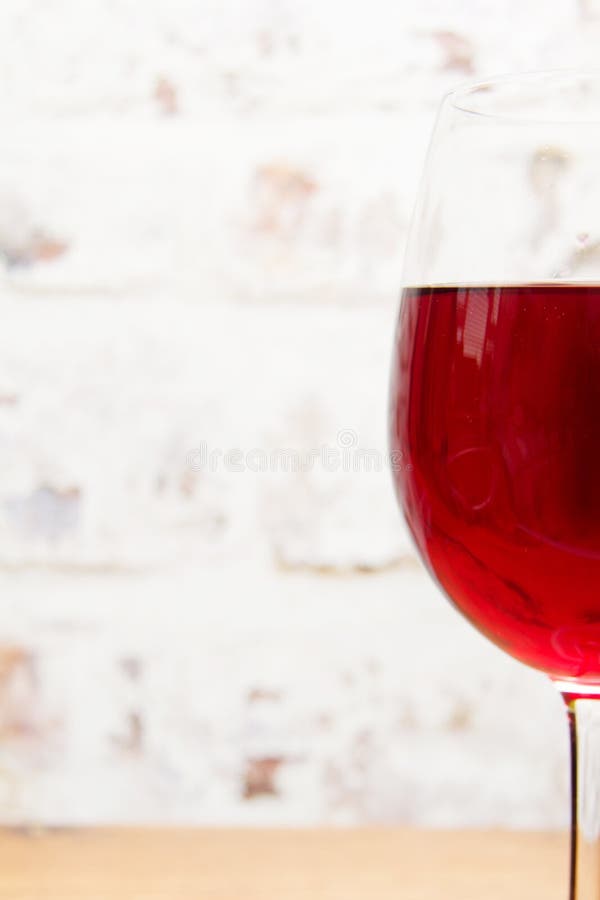 Glass of red wine against rustic background stock image
