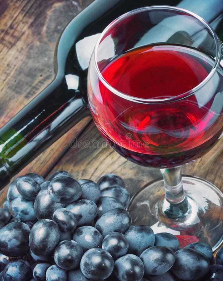 Glass of red wine with bottle royalty free stock images