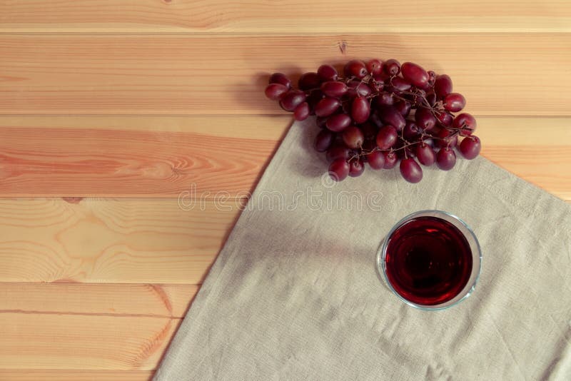 Glass red of wine and red grapes on wooden background stock photo Glass red of wine and red grapes on wooden background stock photo
