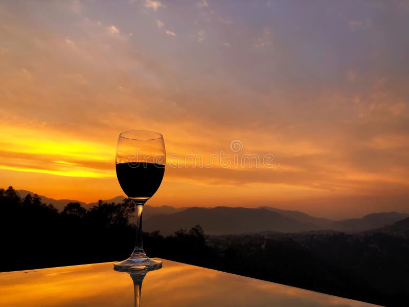 Glass of Red Wine during Sunset Over Himalayan Mountain Range in Nepal