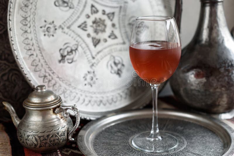 Iced Rose hip Drink. Light Metal Background