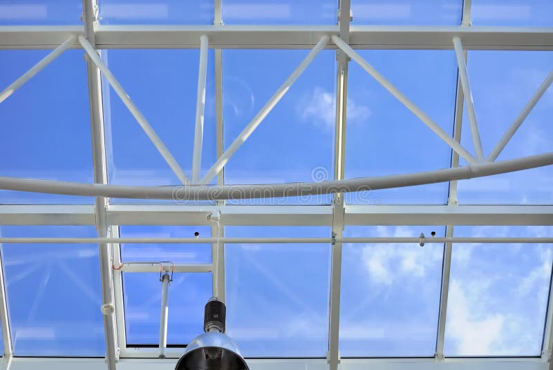 Glass roof with blue sky background