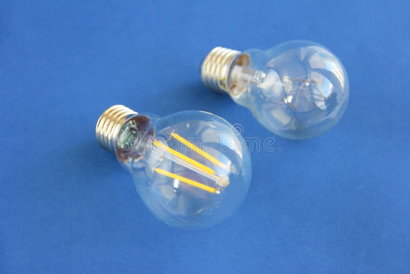 Glass Round Electric Lamps for Lighting on a Blue Background Stock