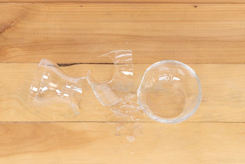 Glass Shattered in Pieces Laying on a Wooden Table Stock Photo Image
