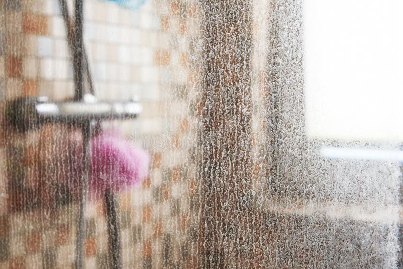 Glass of the shower cabin is completely covered in limescale royalty free stock photos