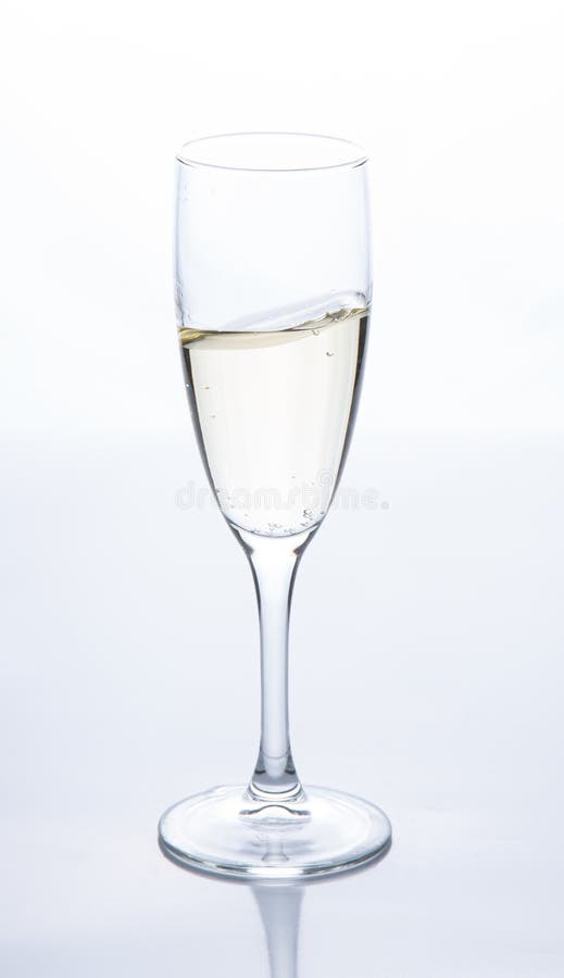 A glass of sparkling champagne is on the table. Contour light. stock image A glass of sparkling champagne is on the table. Contour light. stock image