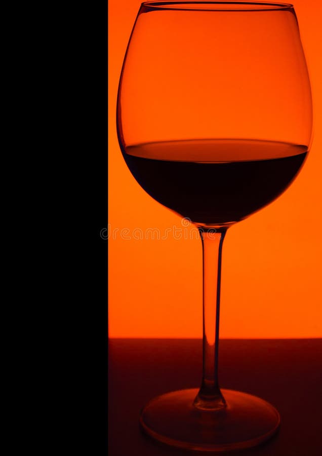 Glass or stemware with alcohol wine,whiskey,gin,beer,rum,vodka,Scotch,cognac,liquor,brandy,absinthe or cocktail on an orange royalty free stock image Glass or stemware with alcohol wine,whiskey,gin,beer,rum,vodka,Scotch,cognac,liquor,brandy,absinthe or cocktail on an orange royalty free stock image