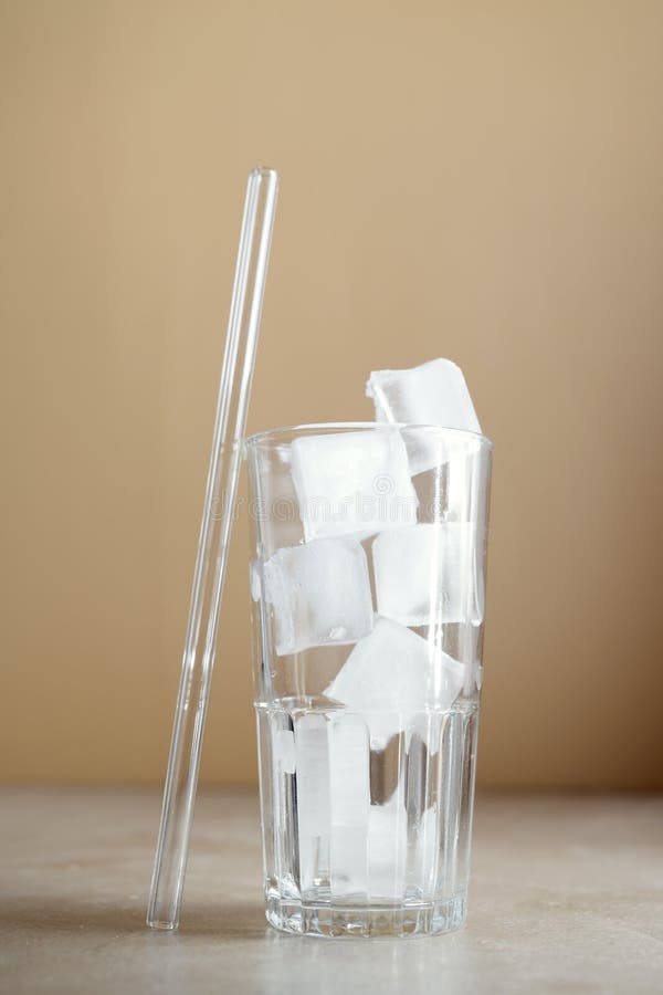 Glass Straw and a Glass with Ice Cubes. Eco Friendly Straw Stock Photo