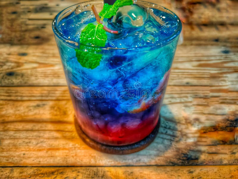 A glass of sweet and fresh mocktail with mint leaves on top stock image