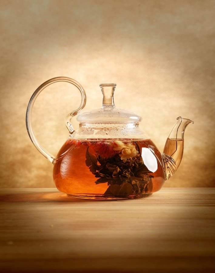 Glass tea pot on the table indoors stock image
