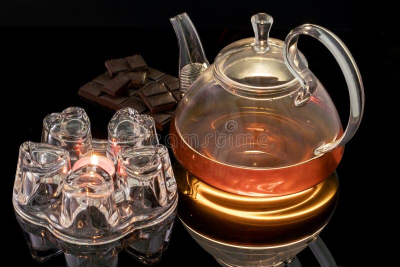 https://thumbs.dreamstime.com/b/glass-teapot-stand-heated-candle-black-background-tea-teapo-chocolate-172134572.jpg