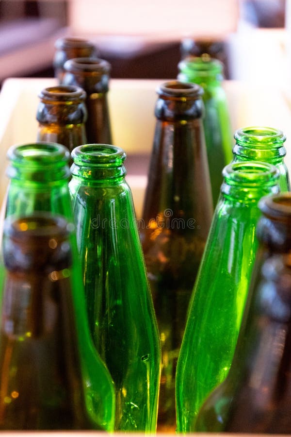 Green and Brown Glass Bottle Tops. Many Empty Glass Bottles. Polished