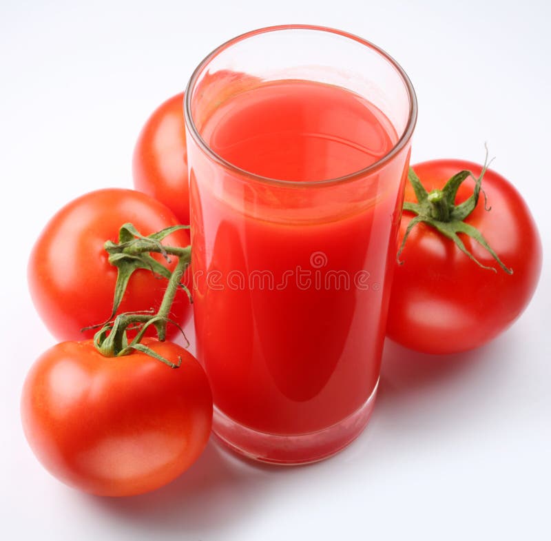 Glass of tomato juice and ripe tomatoes