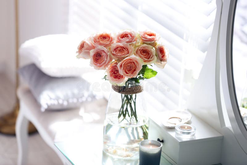 Glass Vase with Beautiful Flowers on Dressing Table in Modern Room