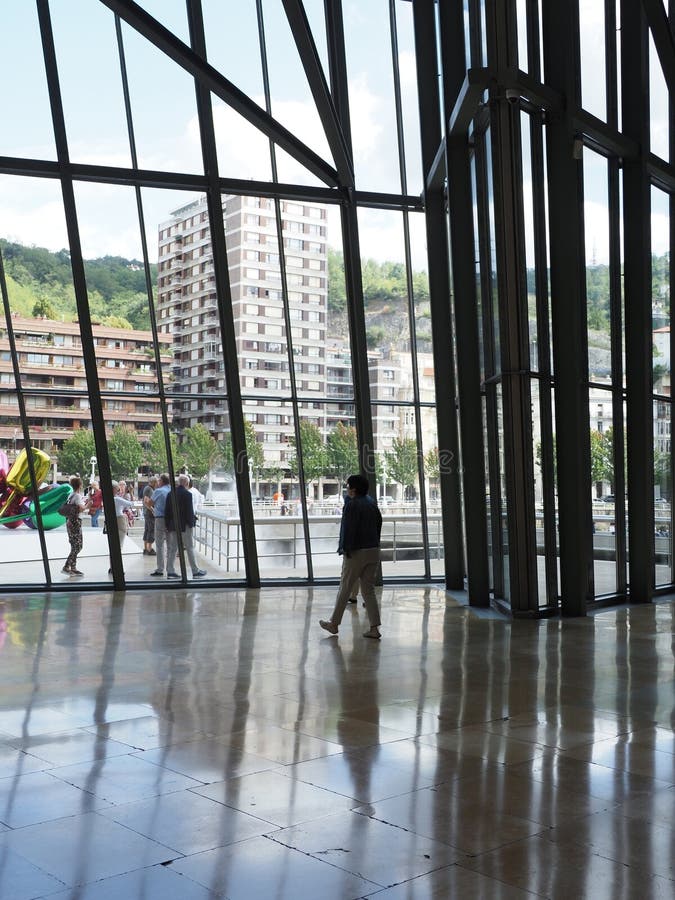 Glass wall in museum building in European BILBAO city at Biscay province in SPAIN in 2019 warm sunny summer day on September - vertical. Glass wall in museum building in European BILBAO city at Biscay province in SPAIN in 2019 warm sunny summer day on September - vertical