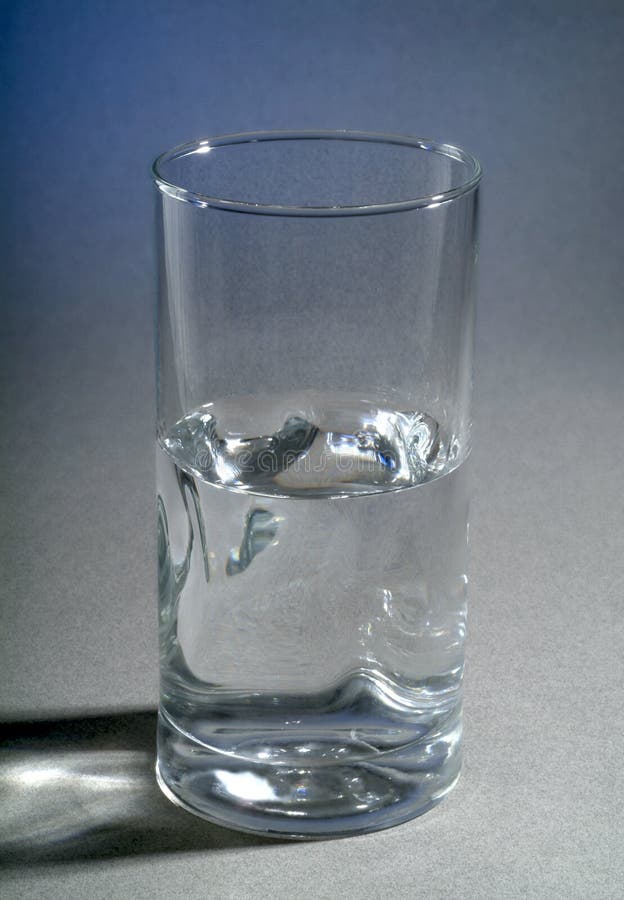 Is the Glass of Water Half Full or Half Empty? Stock Photo Image of