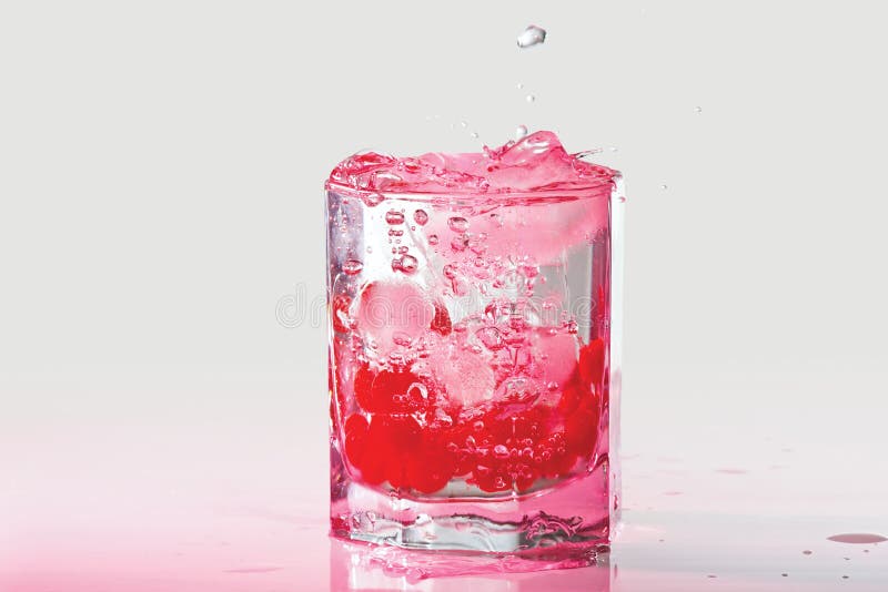 Glass of water, ice and cranberries with splash